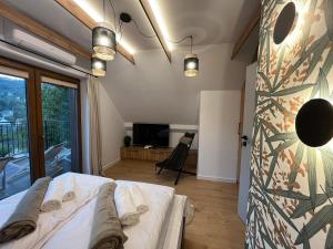 a bedroom with a bed and a large window at Domki Pienińskie Tarasy in Szczawnica