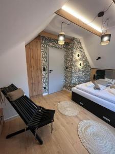 a bedroom with a bed and a chair in it at Domki Pienińskie Tarasy in Szczawnica