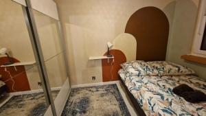 a small bedroom with a bed and a glass wall at Apartament Poselska in Legnica