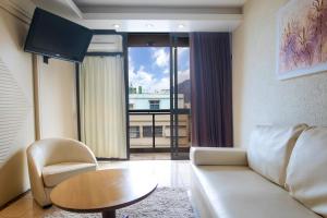 a living room with a couch and a table at Hotel Nacional Inn Rio Copacabana in Rio de Janeiro