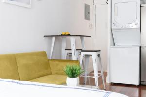 una cucina con divano e tavolo con frigorifero di 24-18 New Gramercy Studio W D in Unit Fully Reno a New York