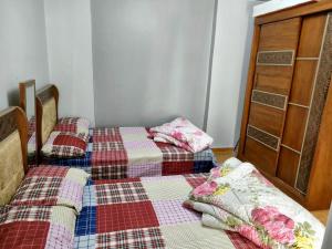 מיטה או מיטות בחדר ב-Alexandria Apartments Hotel