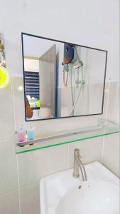 a mirror above a sink in a bathroom at Humairah Homestay - Near Bandar Temerloh in Temerloh