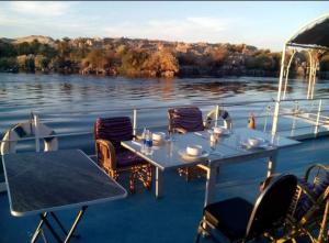 a table and chairs on the deck of a boat at جزيره سهيل in Cairo