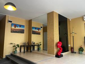 een lobby met een rood standbeeld in een kamer bij APARTHOTEL VICTORY SOFIA in Sofia