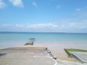 a view of the ocean with rocks in the water at Little Bassett Bed & Breakfast in Totland