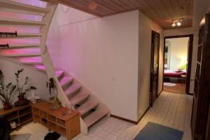 a spiral staircase in a room with a bedroom at Villa Trollbäcken med bastu, värmegolv, öppen spis in Tyresö