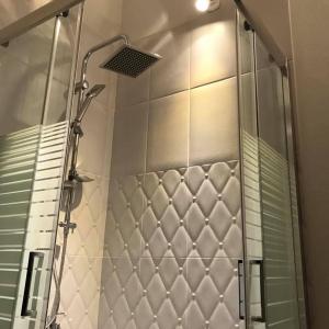a shower with a glass door in a bathroom at SUNIBELROOMS in Paralia Katerinis