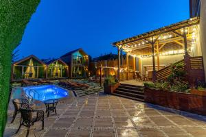 a house with a swimming pool and a patio at wanderholic in Tʼelavi