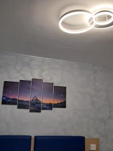 a group of paintings hanging on a wall at Astra in Agerola