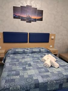 a bedroom with a bed with two towels on it at Astra in Agerola