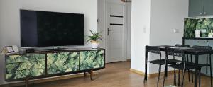 sala de estar con TV de pantalla plana en un centro de entretenimiento en Apartament na Rakoczego en Gdansk