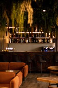 a bar with chairs and a counter with alcohol bottles at Stanislavsky Hotel Group in Yaremche