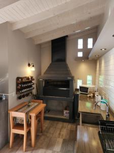 a kitchen with a table and a large oven at La Casita in Junín de los Andes