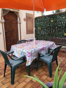 a table with chairs and an umbrella on a patio at Home Sweet Home in Bareggio