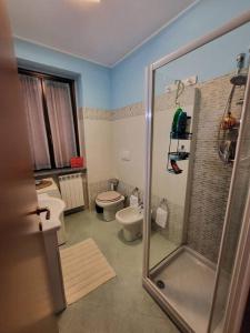 a bathroom with a shower and a toilet and a sink at Home Sweet Home in Bareggio