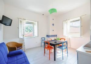 a living room with a dining room table and chairs at Casa Vacanze Nonna Rosaria al centro di Ascea Marina in Ascea