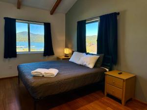 a bedroom with a bed with two towels on it at Lakefront Escape in Big Bear Lake