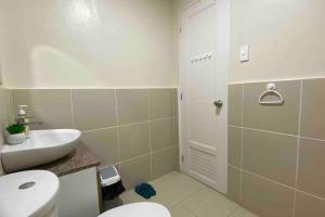 a bathroom with a white toilet and a sink at Mid-rise Condo in Antipolo by Casa Akiolo in Antipolo +49 photos