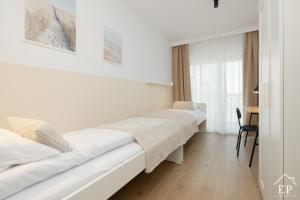 une chambre d'hôtel avec deux lits et un bureau dans l'établissement Apartament MARE 13 Marina Dziwnów & SPA Basen EPapartamenty, à Dziwnów 94 autres photos