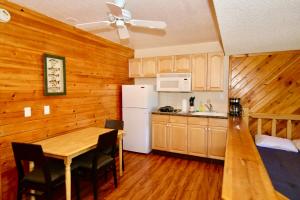 a kitchen and dining room with a table and a refrigerator at Lakefront Escape in Big Bear Lake