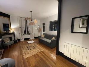 a living room with a couch and a table at Le Relais des Cordeliers in Nancy