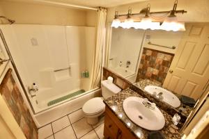 a bathroom with a sink and a toilet and a shower at Lakefront Escape in Big Bear Lake