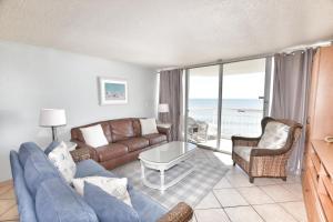 a living room with a couch and a table at 0611 Waters Edge Resort condo in Myrtle Beach