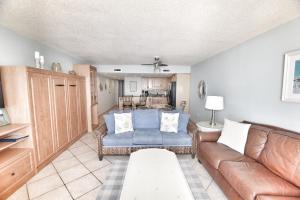a living room with a couch and a table at 0611 Waters Edge Resort condo in Myrtle Beach