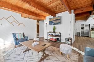 a living room with a table and chairs at Sugarwood -Cozy and relaxing cabin that sits on a tranquil lot! Ping pong and Air Hockey Table! in Sugarloaf