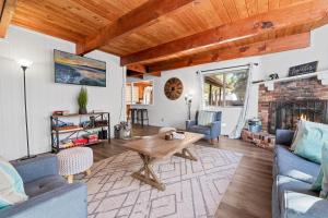 a living room with a table and a fireplace at Sugarwood -Cozy and relaxing cabin that sits on a tranquil lot! Ping pong and Air Hockey Table! in Sugarloaf