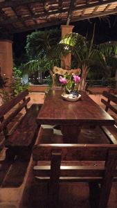 a wooden table with flowers on top of it at The Secret Garden Maratea - Casa di Sery in Maratea