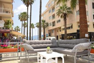 a couch and chairs on a street with palm trees at The Marmaris Boutique Hotel in Marmaris