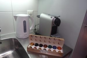 a box of donuts sitting on a counter next to a sink at Aare Studio 2 in Interlaken
