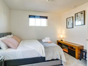 a bedroom with a bed and a desk at Aurora Vacation Rental about 18 Mi to Downtown Denver! in Aurora