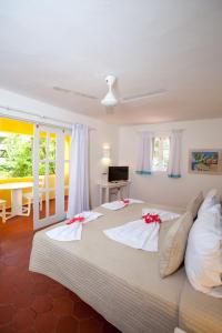 a bedroom with two beds with red bows on them at Los Corales Beach Village Punta Cana - The original in Punta Cana