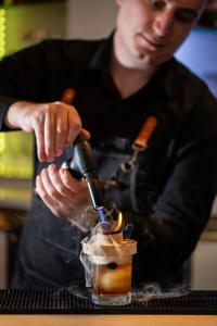 a man pouring a drink into a glass at Delta Hotels by Marriott Edmonton South Conference Centre in Edmonton