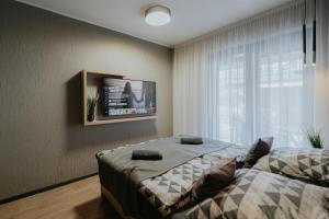 a bedroom with two beds and a tv on the wall at Castle Inn - Szabadkígyós in Szabadkígyós +73 photos