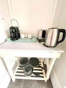 a kitchen counter with pots and pans and a toaster at Ocean Reef Retreat in Perth