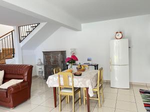 a dining room with a table and a refrigerator at Mine House in Calheta