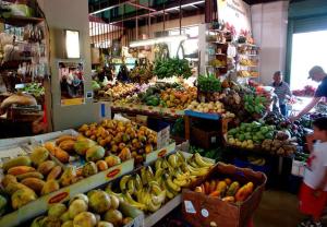 a market with a bunch of fruits and vegetables at Prime Location at Condado Beach 1br 1ba - Apt 8 in San Juan