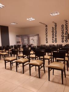 a room with chairs and tables in a room at Maria's Hotel in La Banda