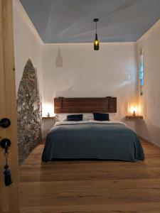 a bedroom with a large bed and a stone wall at Castel San Mauro in Gorizia