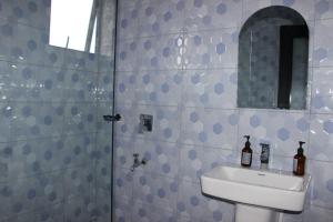 a bathroom with a sink and a shower at MHP Apartments in Munyonyo