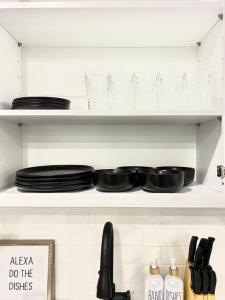 a shelf with plates and dishes on it at Extravagant 3 Bedroom Near art Museum in Philadelphia