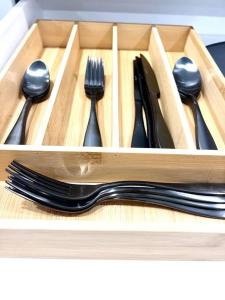 a wooden box with forks and spoons and forks and knives at Extravagant 3 Bedroom Near art Museum in Philadelphia