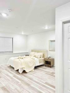 a white bedroom with a bed and a table at Extravagant 3 Bedroom Near art Museum in Philadelphia