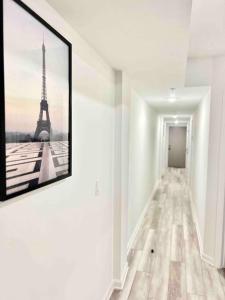 a hallway with a picture of the eiffel tower at Extravagant 3 Bedroom Near art Museum in Philadelphia
