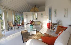 a living room with a couch and a table at The Fan Villa in Port Antonio