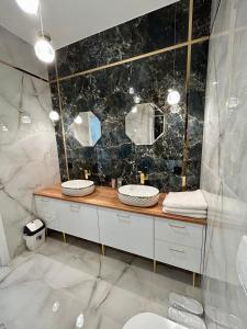 a bathroom with two sinks and two mirrors at Premium Exclusive Suite in Nowy Dwór Mazowiecki +7 photos